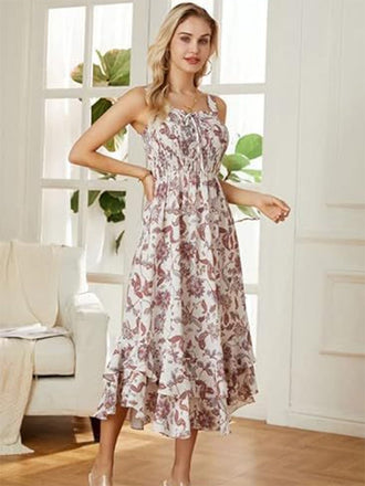 Woman wearing a floral dress in a bright room with large windows.