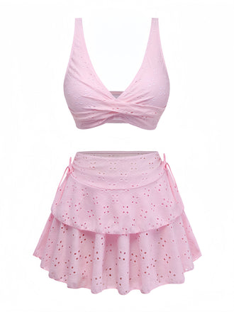 Pink two-piece swimsuit with a top and skirt on a white background