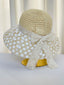 Cappello di paglia lavorato all'uncinetto con pizzo floreale