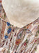 Close-up of a floral-patterned fabric with a soft beige background