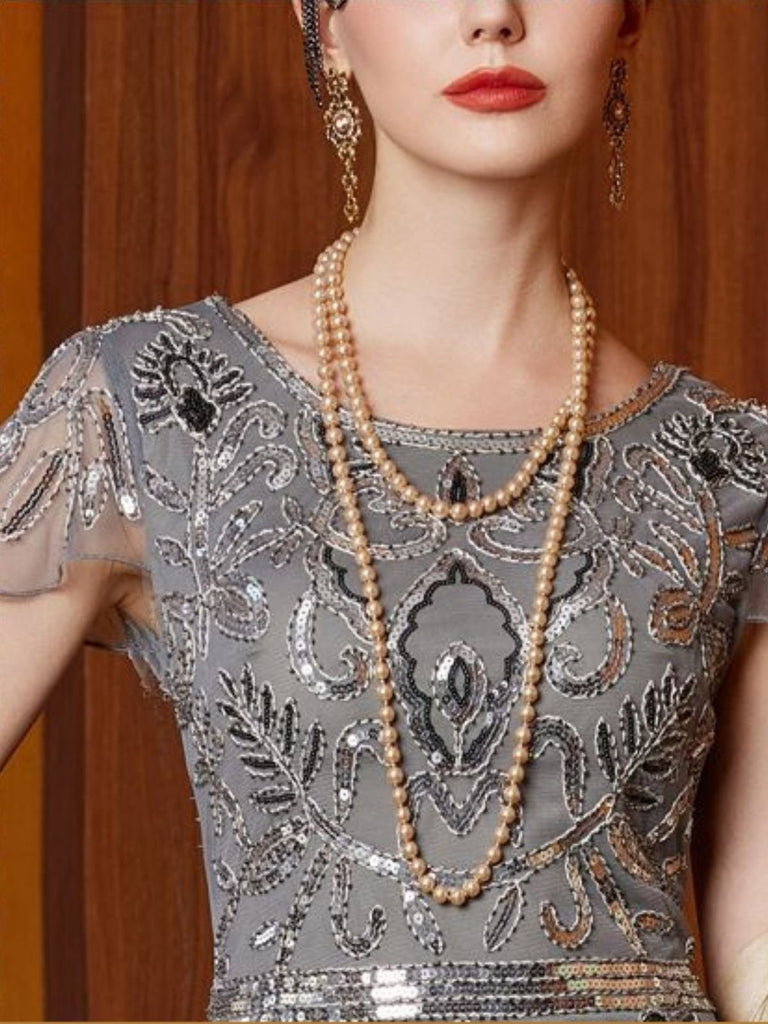 Abito con paillettes e maniche ad aletta in tulle grigio anni '20