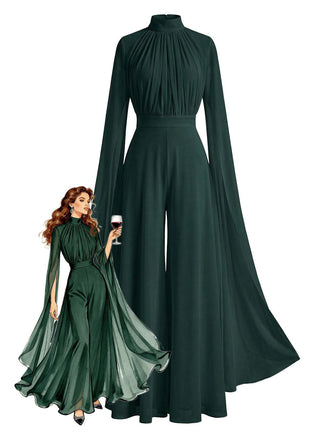 Abito da sera verde con maniche lunghe e dettaglio simile a un mantello, indossato da una modella che tiene in mano un bicchiere di vino.