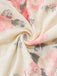 A swirled close-up of the cream fabric highlighting the soft texture and detailed rose print.