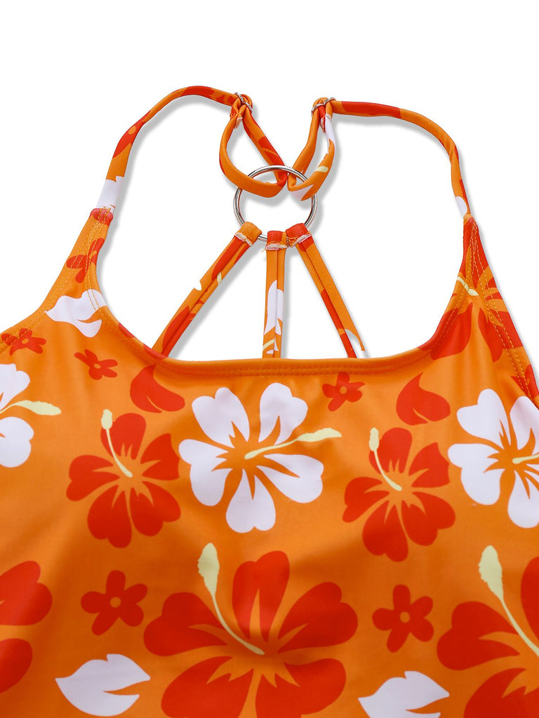 Close-up of the polished silver metal ring connecting the orange floral print straps on the back of the swimsuit.