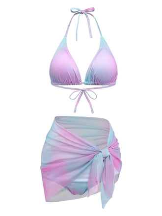 A three-piece swimwear set featuring a triangle halter bikini top, matching bottoms, and a sheer mesh tie-front sarong in a blue, pink, and purple ombre print.