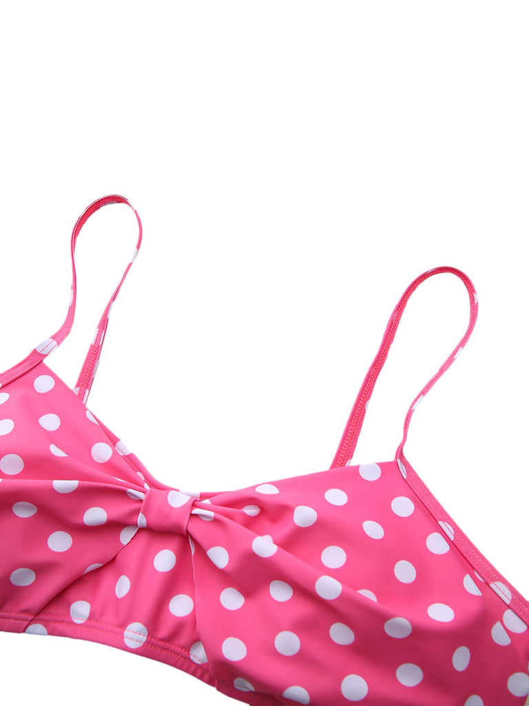 Close-up of the pink and white polka dot bikini top, showcasing the central bow detail and adjustable straps.
