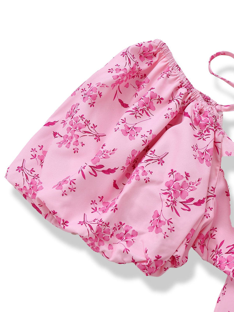 Close-up of the elasticated puff sleeve and the intricate pink-on-pink floral pattern.